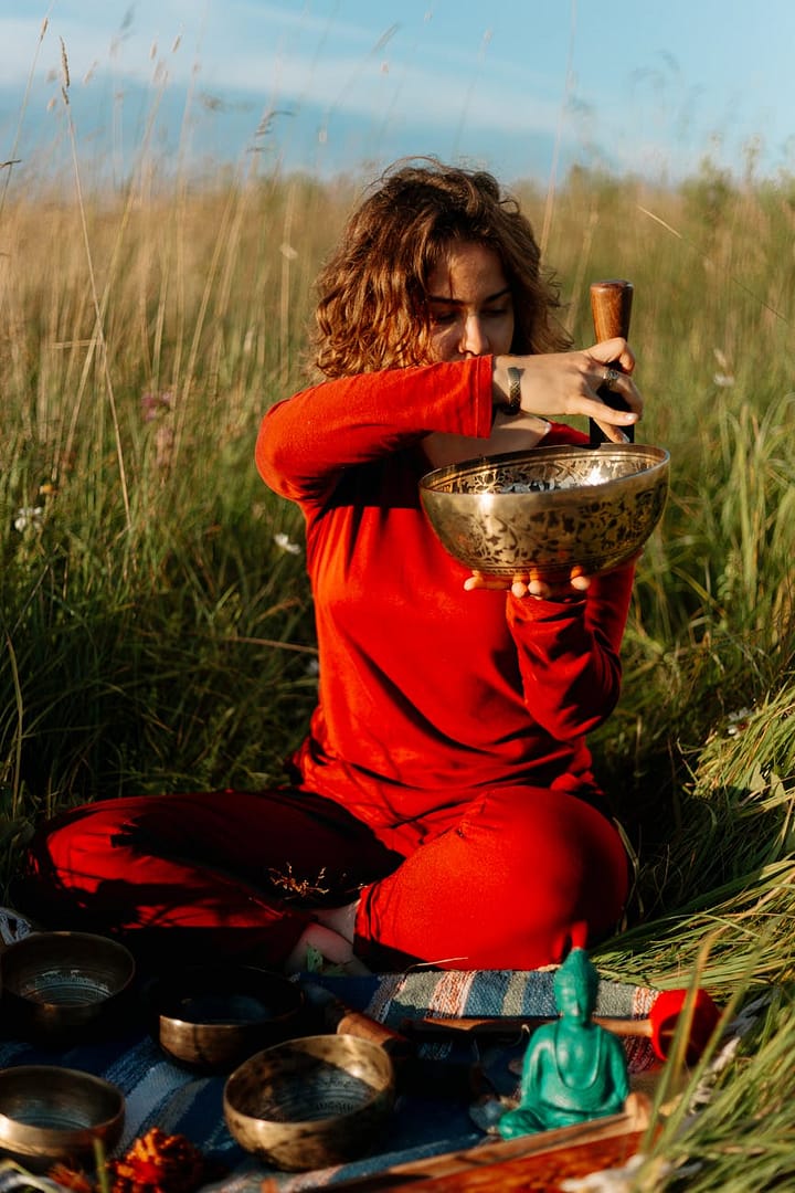 woman plays on a tibetan singing bowl