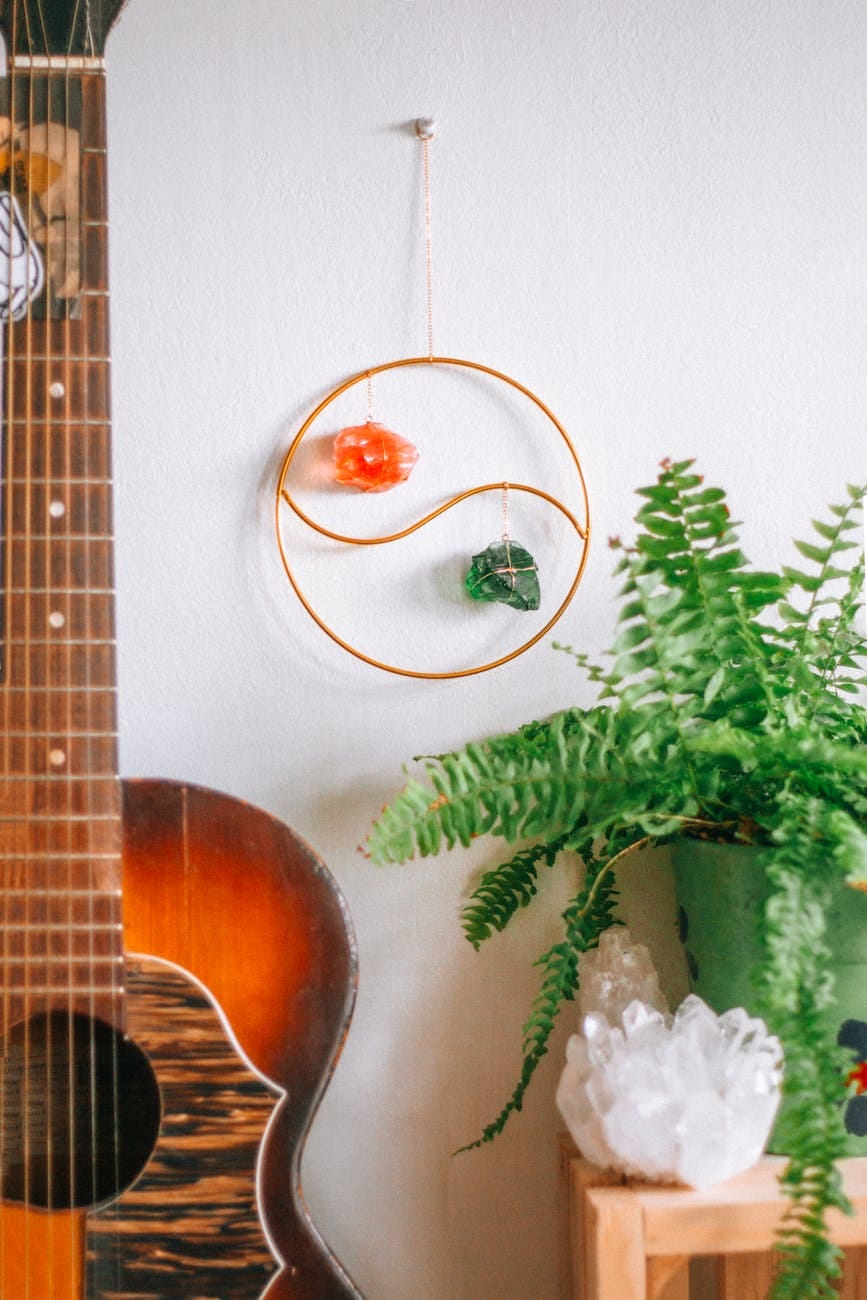 a guitar and a wall hanging with a guitar